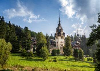 Amazing panoramic picture of the beautiful Peles Castle and its beautiful gardens near Sinaia, Romania