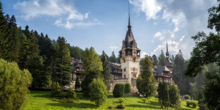 Amazing panoramic picture of the beautiful Peles Castle and its beautiful gardens near Sinaia, Romania