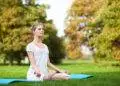 Young girl doing yoga in the park