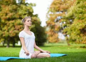 Young girl doing yoga in the park